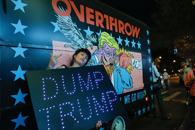 A woman poses next to the Knockout Trump Truck outside the IFC Theater, ahead of the premiere of Michael Moore in TrumpLand. Photograph: Kena Betancur/AFP/Getty Images 